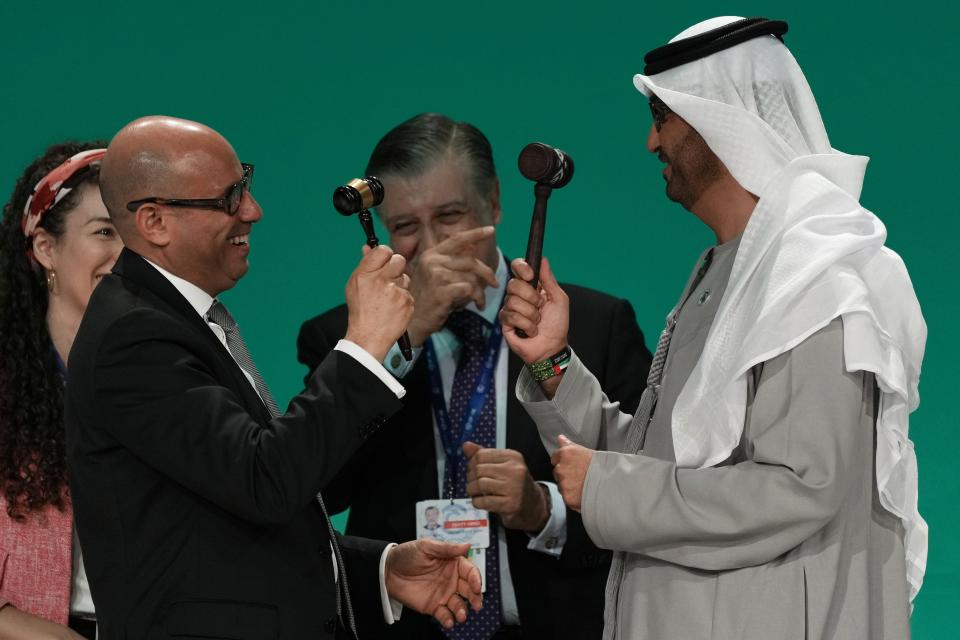 COP28 President Sultan al-Jaber and United Nations Climate Chief Simon Stiell both hold gavels at the end of the COP28 U.N. Climate Summit, Wednesday, Dec. 13, 2023, in Dubai, United Arab Emirates. (AP Photo/Kamran Jebreili)