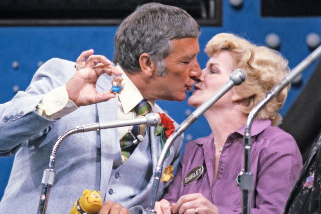 <p>ABC Photo Archives/Disney General Entertainment Content via Getty Images</p> 'Family Feud' host Richard Dawson smooches a contestant