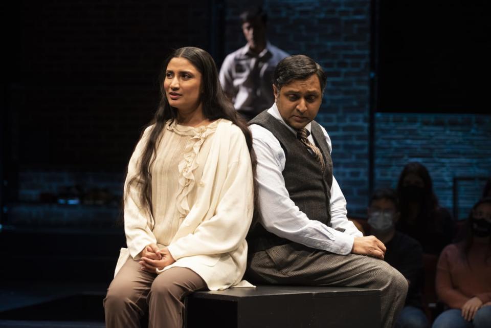 <div class="inline-image__caption"><p>Dhatta (Gulshan Mia) and Charu (Bhavesh Patel), with Sanskar Agarwal in the background in "Elyria."</p></div> <div class="inline-image__credit">Ahron R. Foster</div>