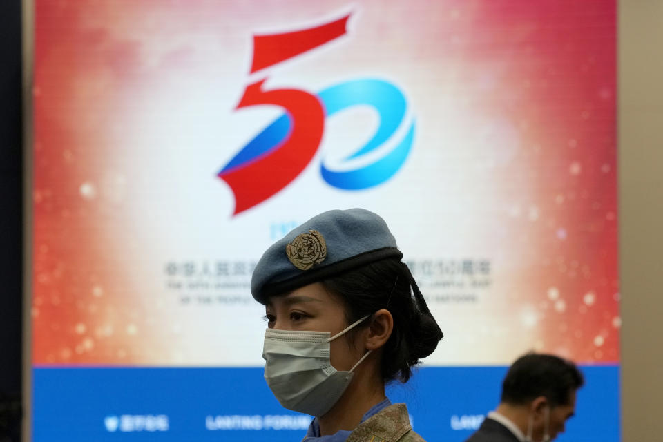 A Chinese United Nations peacekeeper attends a symposium to mark the 50th anniversary of the People's Republic of China's entry into the U.N. at the Foreign Ministry in Beijing on Friday, June 25, 2021. Foreign Minister Wang Yi said China remains deeply committed to United Nations peacekeeping efforts, where more than 2,400 Chinese troops and police are serving, a contribution that underscores China's increasing prominence in the world body. (AP Photo/Ng Han Guan)