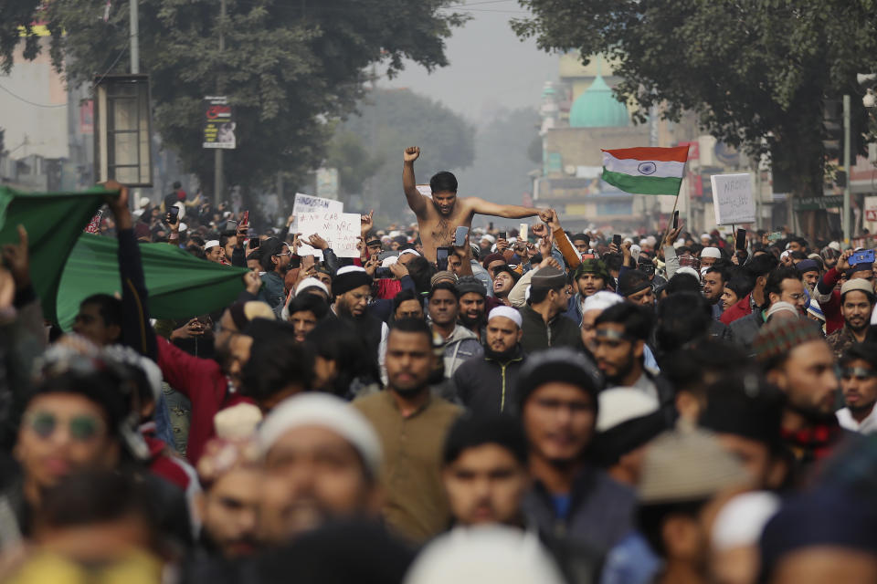 Indians march through a street during a protest against the Citizenship Amendment Act after Friday prayers in New Delhi, India, Friday, Dec. 20, 2019. Police banned public gatherings in parts of the Indian capital and other cities for a third day Friday and cut internet services to try to stop growing protests against a new citizenship law that have so far left more than 10 people dead and more than 4,000 others detained. (AP Photo/Altaf Qadri)