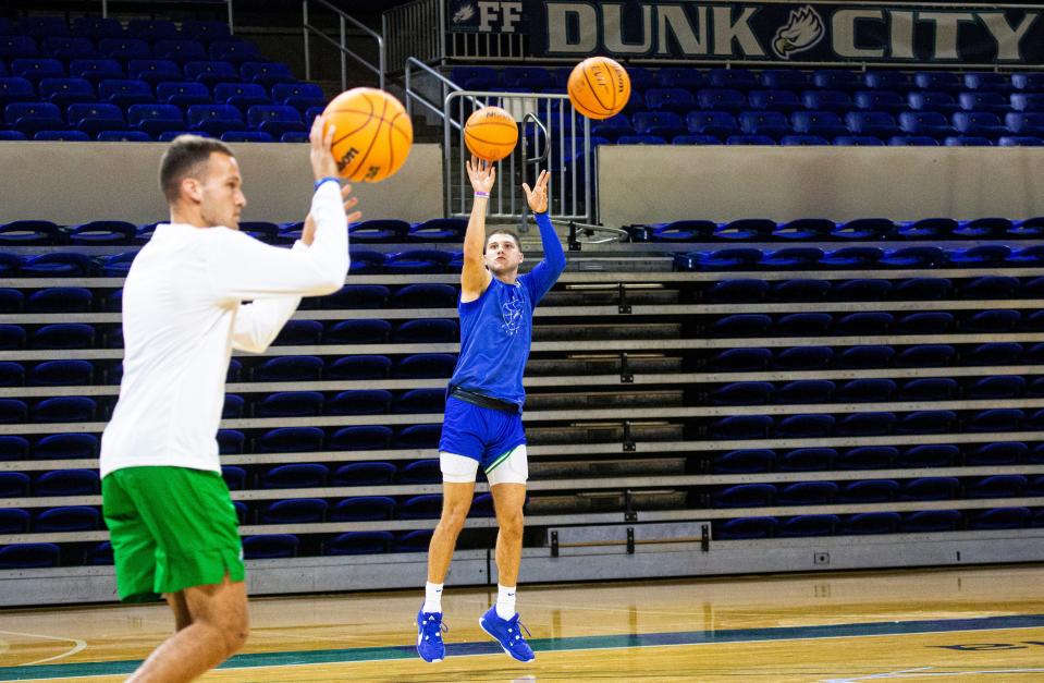 Chase Johnston, #55, right, , of the Florida Gulf Coast University basketball team shoots during a practice on Tuesday, Sept. 26, 2023.