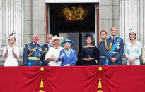 <p>Meghan Markle, fourth right, stands between the Queen and new husband Prince Harry as members of the Royal Family watch a flypast to mark the centenary of the RAF. (Getty)</p> 