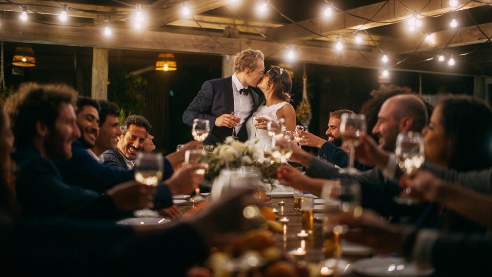 Bride and Groom kiss at a wedding reception