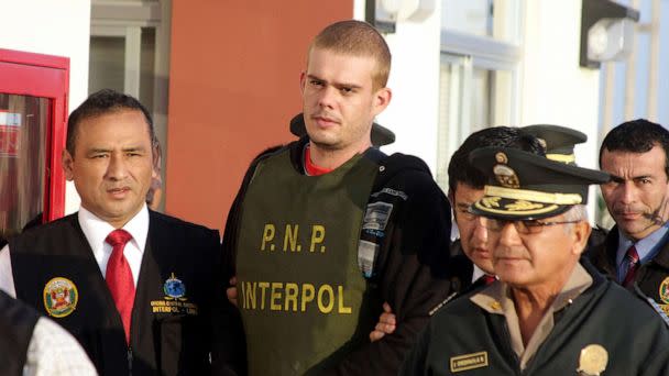 PHOTO: In this June 4, 2010, file photo, Joran van der Sloot is escorted by police after being handed over by Chilean authorities at the border between both countries in Tacna, 1,250 kilometers south of Lima, Peru. (Sebastian Silva/AFP via Getty Images, FILE)