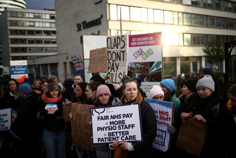 NHS physiotherapists stand at a picket line as they strike outside St Thomas' Hospital in London on Jan. 26, 2023.<span class="copyright">Henry Nicholls—Reuters</span>
