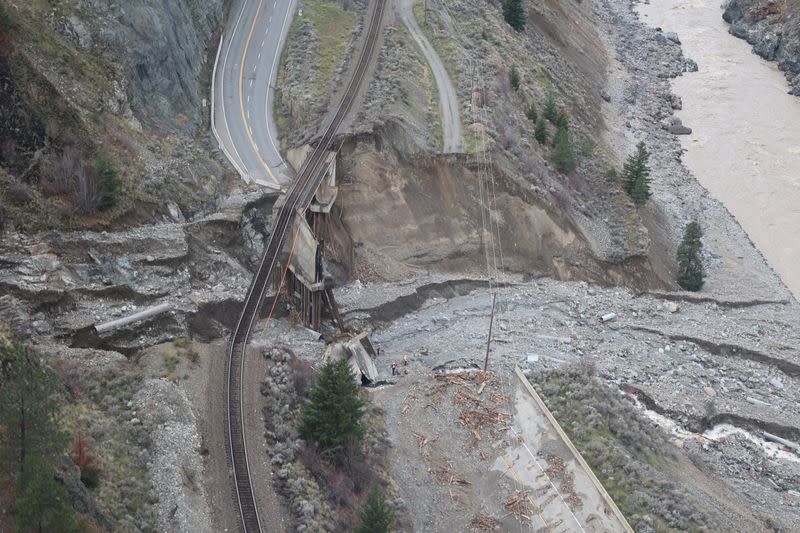 Railway tracks are suspended above the washed out Tank Hill underpass of the Trans Canada Highway 1