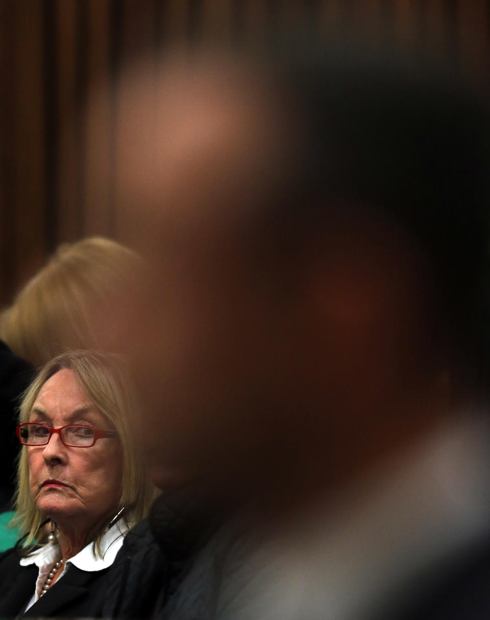 June Steenkamp, left, mother of the late Reeva Steenkamp, looks at Oscar Pistorius, front, in court while listening to forensic evidence in Pretoria, South Africa, Thursday, April 17, 2014. Pistorius is charged with the murder of his girlfriend, Steenkamp, on Valentines Day in 2013. (AP Photo/Themba Hadebe, Pool)