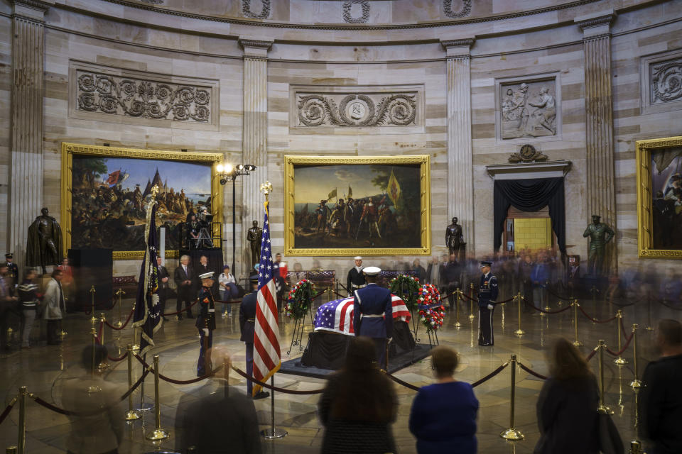 Members of the public file through the Capitol Rotunda to view the casket.