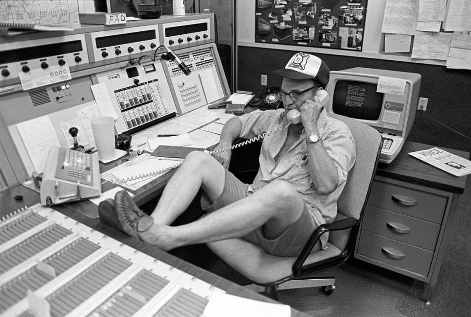 July 3, 1980: Fort Worth fire dispatcher Frank Calaway answers the phone in shorts and moccasins after an air conditioning failure at the office. City officials are allowing informal dress and six-hour shifts to ease the effects of searing heat. Ron T. Ennis/Fort Worth Star-Telegram archive/UT Arlington Special Collections