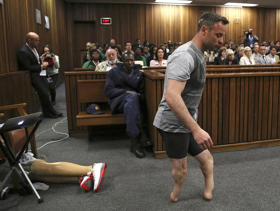 FILE - Olympic runner Oscar Pistorius' prosthetics lay on the floor as he walks on his amputated legs during argument in mitigation of sentence by his defence attorney Barry Roux in the High Court in Pretoria where he appeared for the murder of his girlfriend Reeva Steenkamp, on June 15, 2016. Pistorius has applied for parole and is expected to attend a hearing on Friday, March 31, 2023 that will decide if the former Olympic runner is released from prison 10 years after killing girlfriend Reeva Steenkamp. (Siphiwe Sibeko/Pool Photo via AP,File)