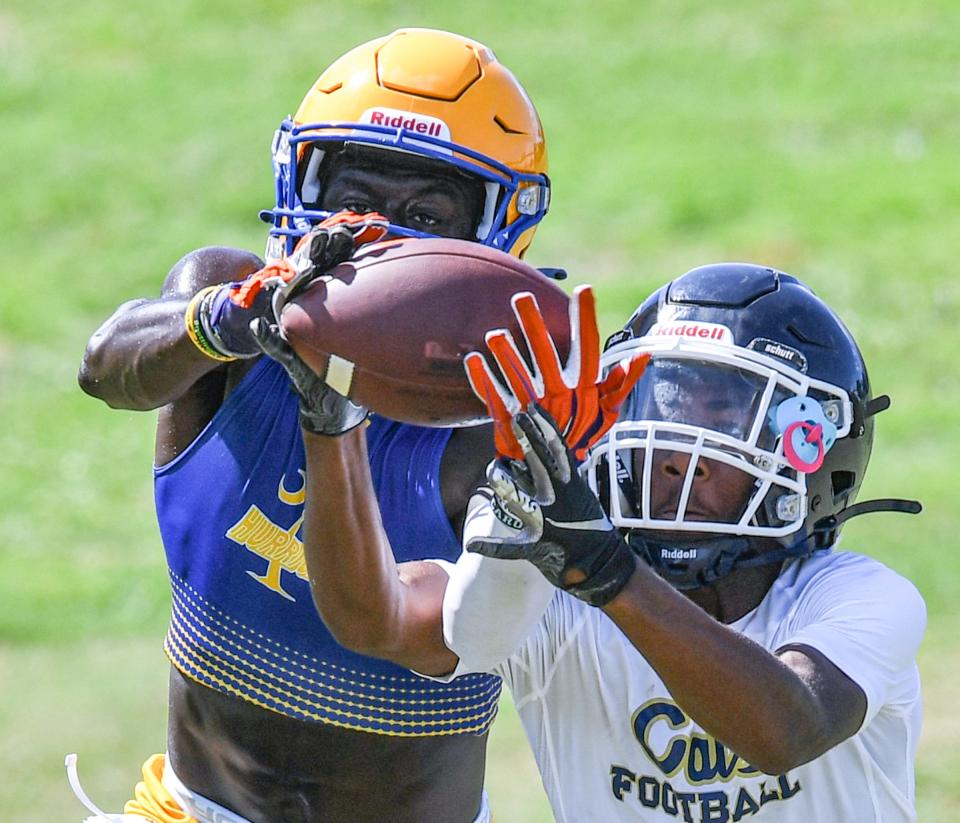 Wren High cornerback Travon West, left, intercepts a ball intended for Seneca High receiver Keyshawn Garrison during the Westside 7 on 7 at Westside High School in Anderson, S.C. Thursday, July 1, 2021. 