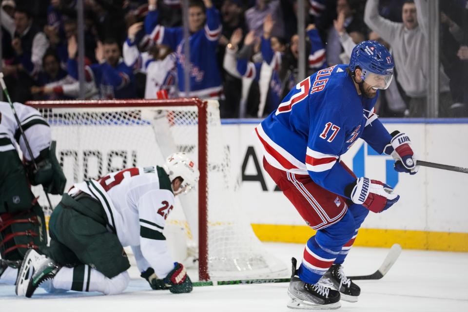 New York Rangers' Blake Wheeler (17) celebrates after scoring as Minnesota Wild's Jonas Brodin (25) kneels on the ice during the third period of an NHL hockey game Thursday, Nov. 9, 2023, in New York. (AP Photo/Frank Franklin II)