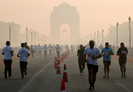 FILE PHOTO: Participants run during a half marathon organised by Indian National Security Guard (NSG) on a smoggy morning in New Delhi, India, November 18, 2018. REUTERS/Altaf Hussain