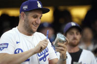 A fan bangs on a miniature trash can as the Houston Astros play the Los Angeles Dodgers during the third inning of a baseball game Tuesday, Aug. 3, 2021, in Los Angeles. (AP Photo/Marcio Jose Sanchez)