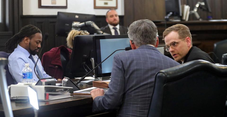 Summit County Assistant Prosecutors Zachary Neumann, right, and Greg Peacock speak with each other during Dacarrei Kinard's murder trial Monday in Judge Kathryn Michael's courtroom at the Summit County Courthouse.