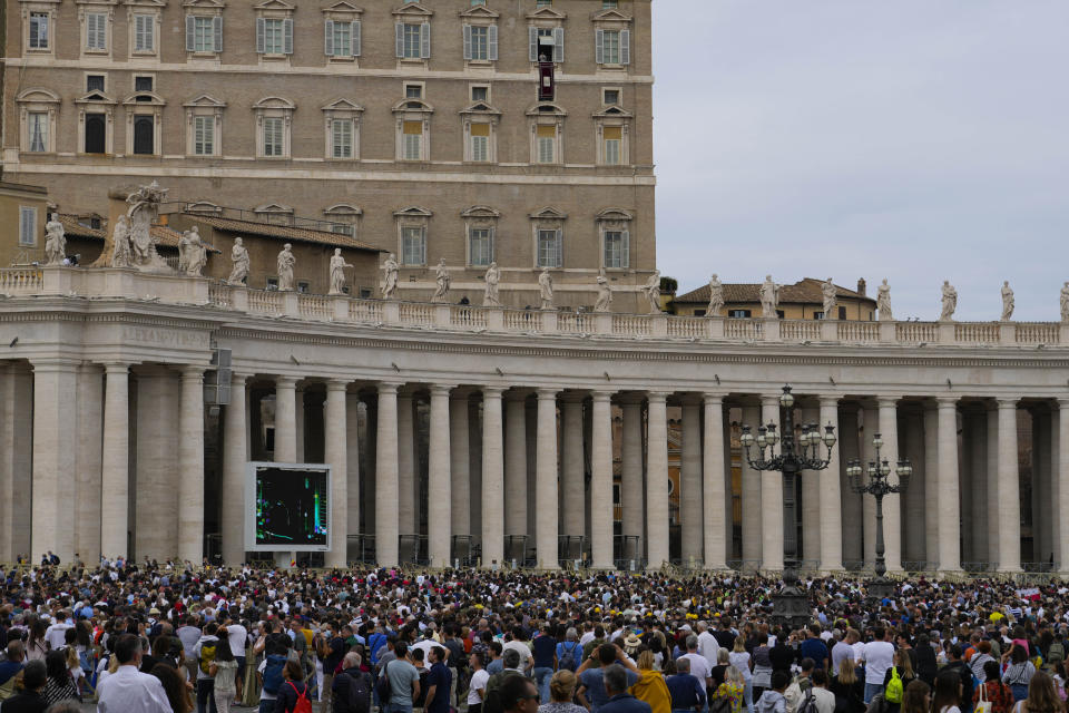 Faithful and pilgrims listen to Pope Francis' speech during the Angelus noon prayer from the window of his studio overlooking St.Peter's Square, at the Vatican, Sunday, Oct. 3, 2021. (AP Photo/Alessandra Tarantino)