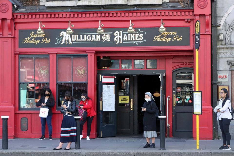 People wearing masks outside a pub (PA)