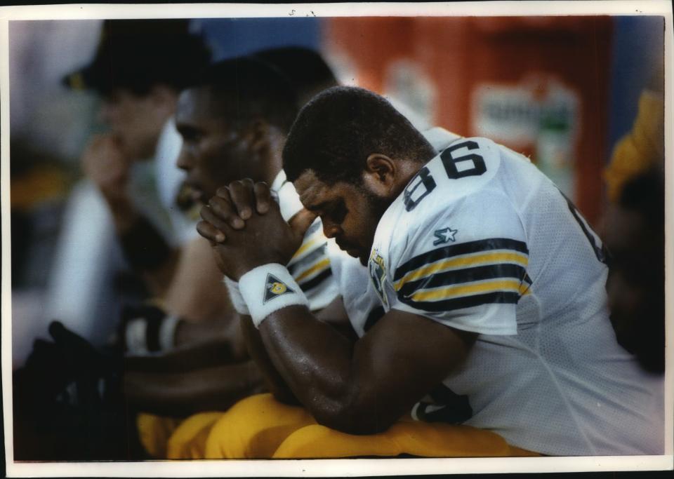 A dejected Ed West sits on the bench late in the fourth quarter of Green Bay's season-finale loss to Detroit.