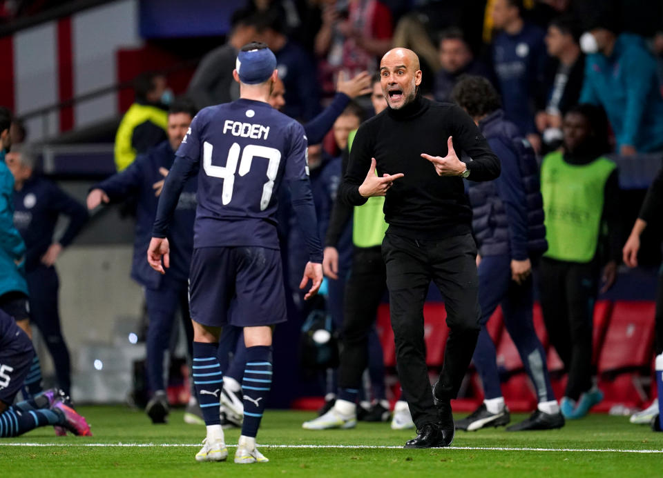 Manchester City manager Pep Guardiola (right) speaks to Phil Foden during the UEFA Champions League quarter final, second leg match at the Wanda Metropolitano Stadium, Madrid. Picture date: Wednesday April 13, 2022. (Photo by Nick Potts/PA Images via Getty Images)