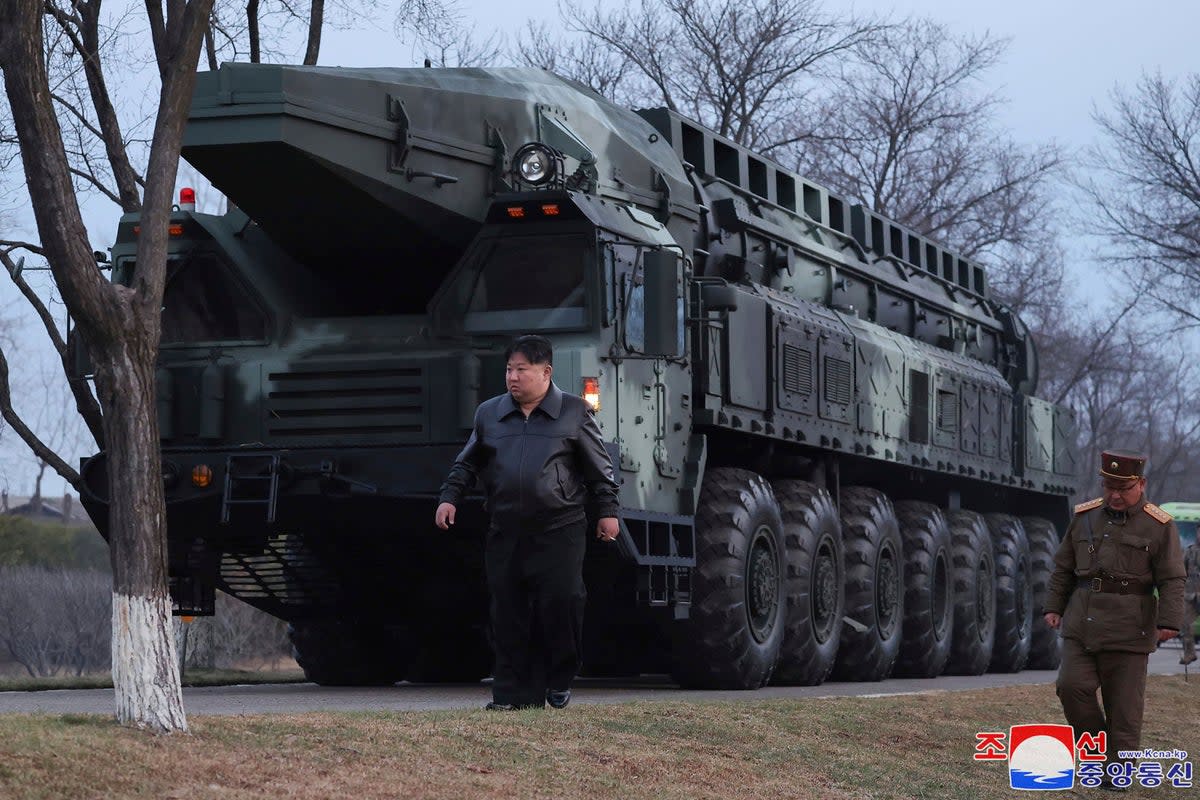 File: North Korean leader Kim Jong-un, center, walks by a missile launcher  (AP)