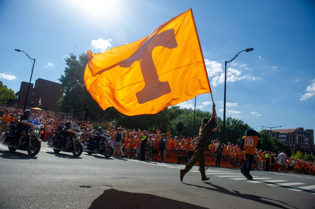 Davy Crockett waves the Tennessee flag during the Vol Walk.