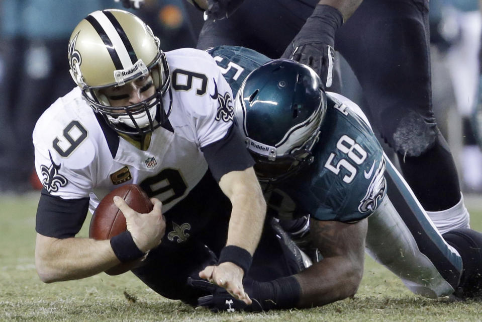Philadelphia Eagles' Trent Cole (58) tackles New Orleans Saints' Drew Brees (9) during the first half of an NFL wild-card playoff football game, Saturday, Jan. 4, 2014, in Philadelphia. (AP Photo/Matt Rourke)