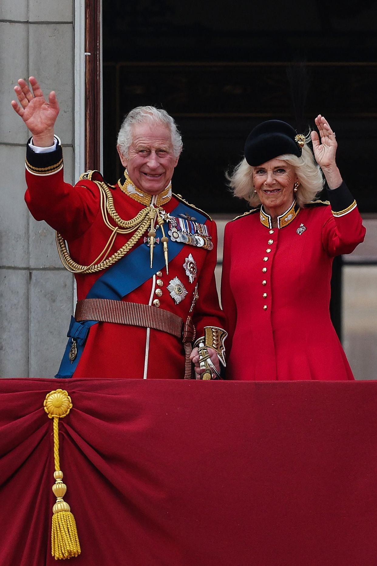 King Charles III and Queen Camilla wave from the balcony of Buckingham Palace (AFP via Getty Images)