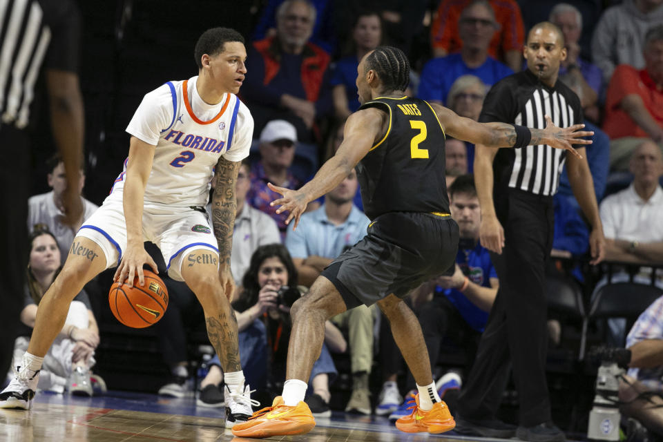 Florida guard Riley Kugel (2) gets pressure from Missouri guard Tamar Bates (2) during the first half of an NCAA college basketball game Wednesday, Feb. 28, 2024, in Gainesville, Fla. (AP Photo/Alan Youngblood)
