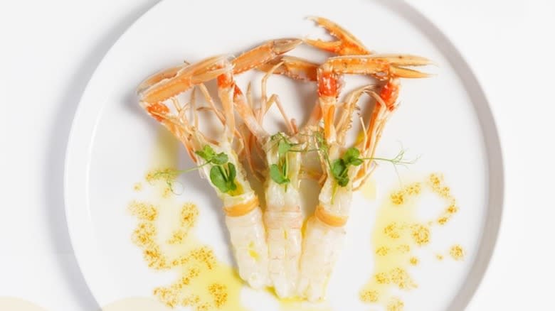 three pieces of scampi with honey on white plate