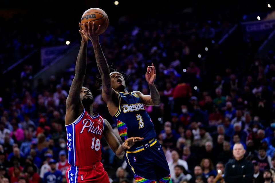 Denver Nuggets' Bones Hyland, right, goes up for a shot against Philadelphia 76ers' Shake Milton during the first half of an NBA basketball game, Monday, March 14, 2022, in Philadelphia. (AP Photo/Matt Slocum)