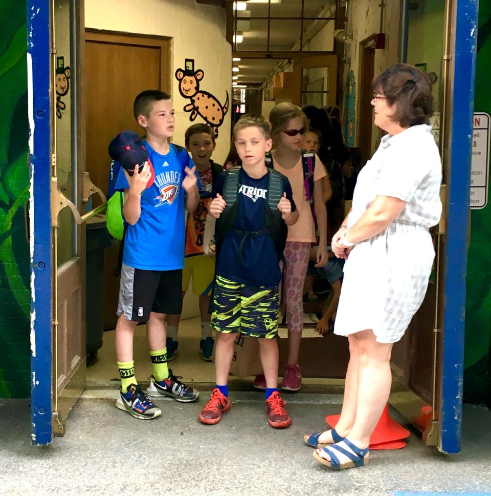 Dominic Crisafulli, left, and Pat Mulholland, center, wait to leave Johnson School for the last time as fourth-graders on the cusp of summer break.