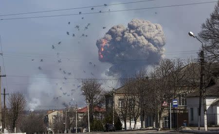 Flames shoot into the sky from a warehouse storing tank ammunition at a military base in the town of Balaklia (Balakleya), Kharkiv region, Ukraine, March 23, 2017. REUTERS/Alexander Sadovoy