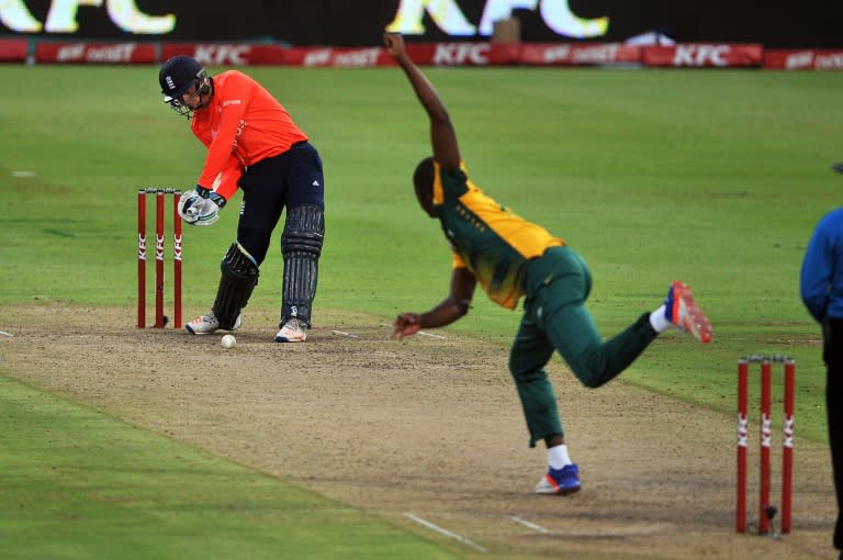 England's Jos Buttler plays a shot off a ball from South Africa's bowler Kagiso Rabada (R) during the first Twenty20 (T20) international cricket match between South Africa and England on February 19, 2016, at Newlands Cricket Ground in Cape Town