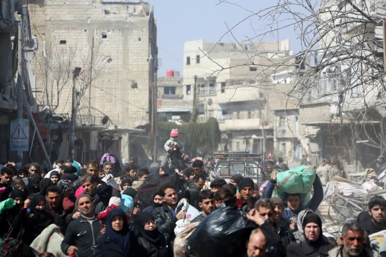 Syrian civilians evacuate the town of Jisreen in Eastern Ghouta towards areas under government control on March 17, 2018