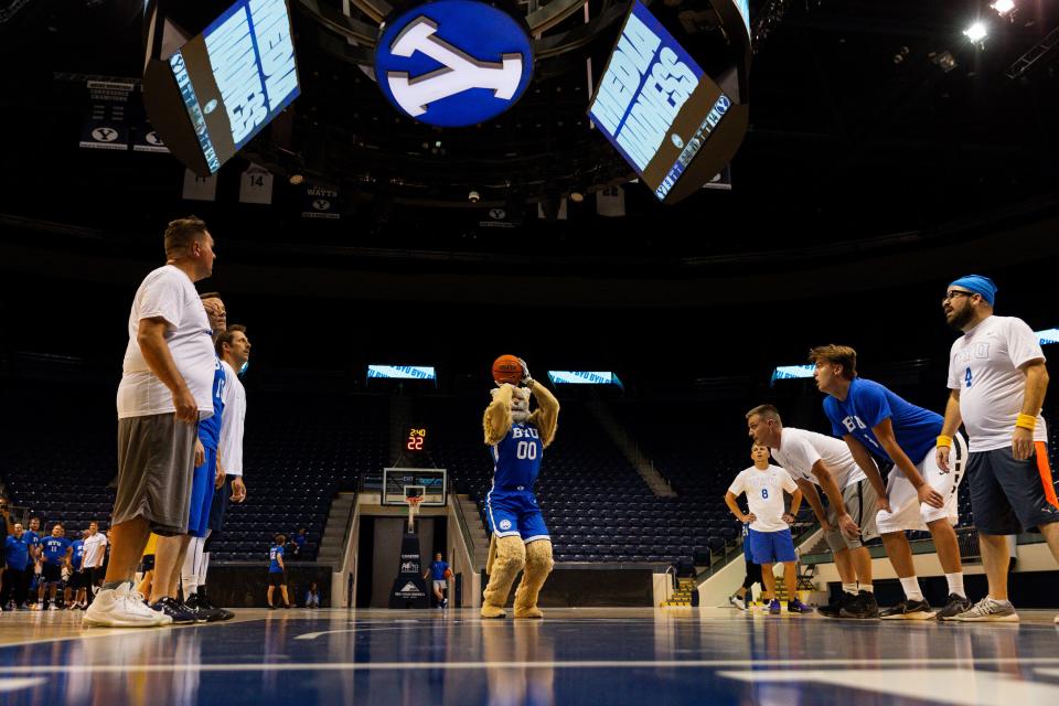 Cosmo shoots a free throw with members of the media around the key at Media Madness, an event hosted by BYU men’s basketball program, at the Marriott Center in Provo on Monday, Oct. 9, 2023. | Megan Nielsen, Deseret News