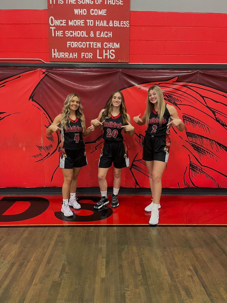 From left to right, Jena Guilliams, Sophia Spangler and Corri Vermilya pose together in their uniforms on Team Picture Day.
