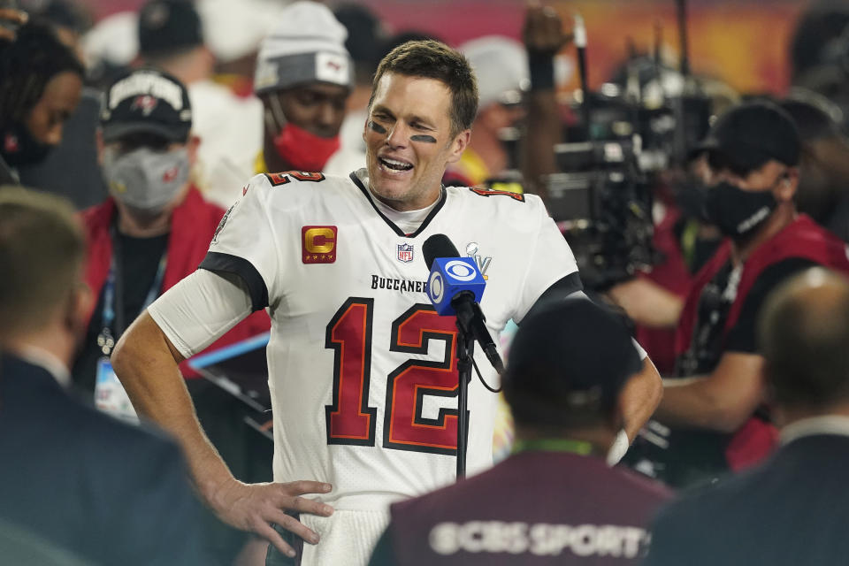 FILE - Tampa Bay Buccaneers quarterback Tom Brady (12) is interviewed on the field after the NFL Super Bowl 55 football game against the Kansas City Chiefs, in Tampa, Fla., in this Sunday, Feb. 7, 2021, file photo. Sometimes, the abdicating king, or the deposed one, returns to his kingdom. It happens often enough in the NFL, yet rarely is as newsworthy as Tom Brady, who led the Patriots to six Super Bowl titles, going back to New England. He'll do that on Sunday night eight months after taking the Tampa Bay Buccaneers to the top. (AP Photo/Steve Luciano, FIle)