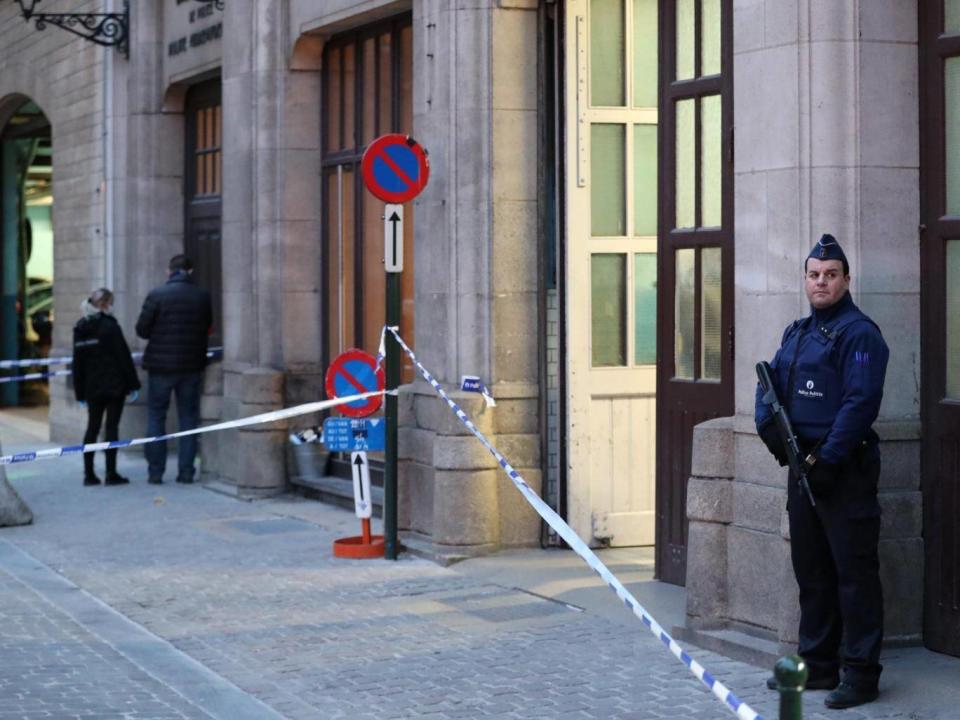 Police keep watch outside the police headquarters after a policeman was stabbed in Brussels (REUTERS/Yves Herman)