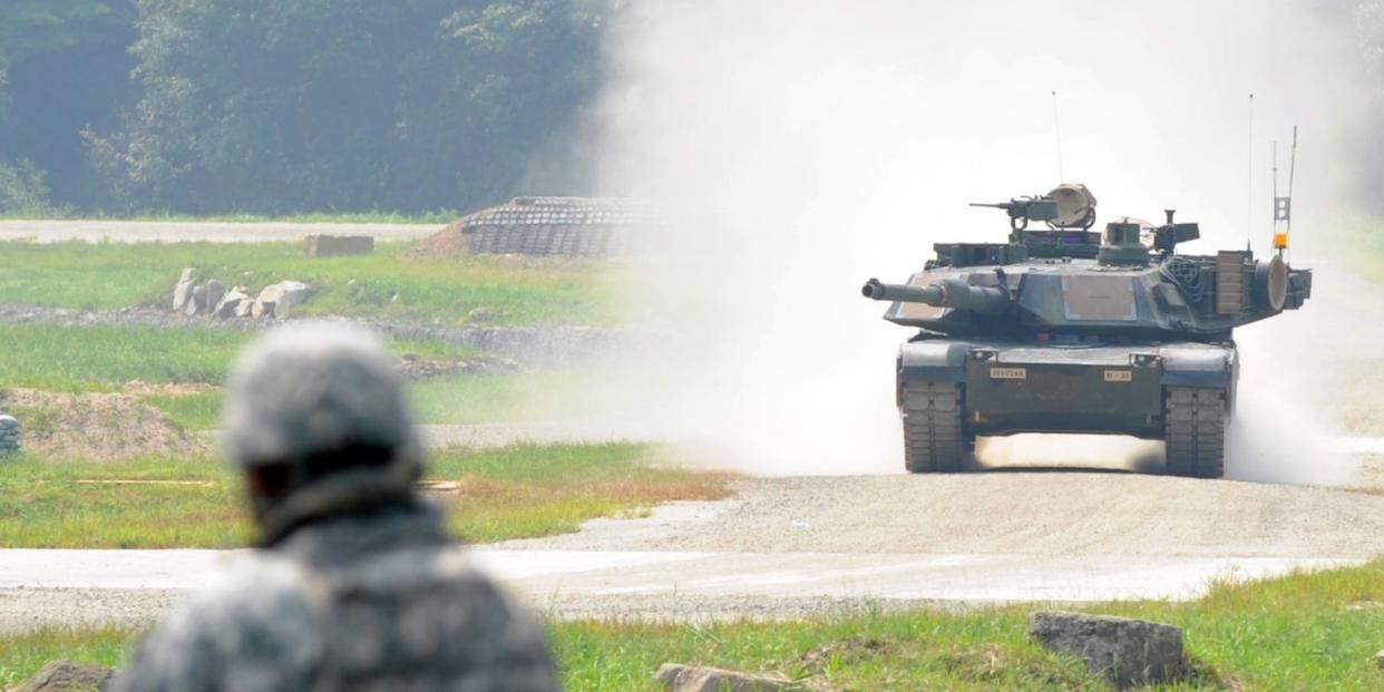 a us soldier looks at a m1a2 sep abrams