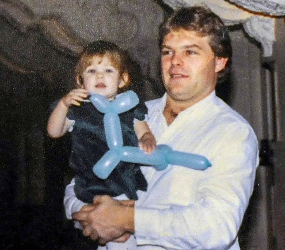 Kevin Harkins holding his daughter Jessica in an undated family photograph.