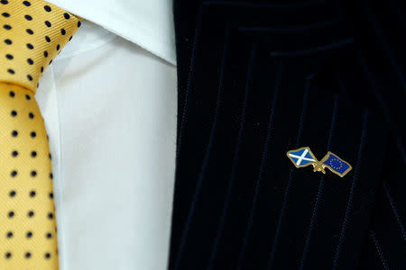 Michael Russell, Minister for UK Negotiations on Scotland's Place in Europe, wears a pin with Scottish and EU flags during an interview with Reuters in Brussels, Belgium March 13, 2017. REUTERS/Francois Lenoir