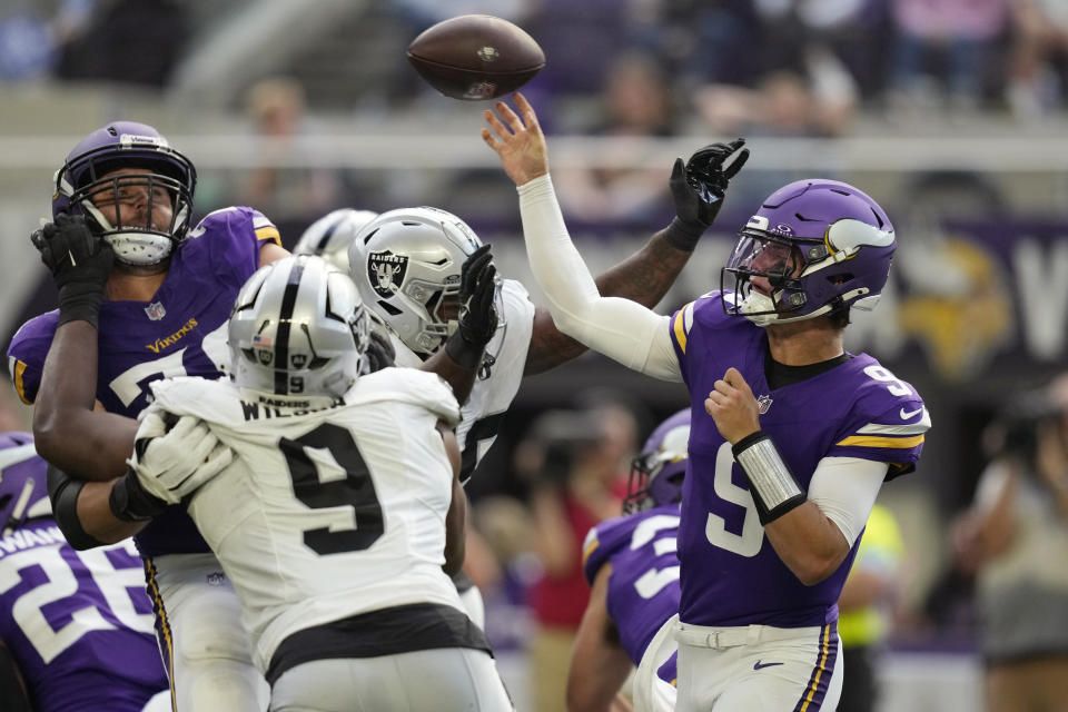 Minnesota Vikings quarterback J.J. McCarthy (9) throws against the Las Vegas Raiders under pressure during the first half of an NFL football game Saturday, Aug. 10, 2024, in Minneapolis. (AP Photo/Charlie Neibergall)