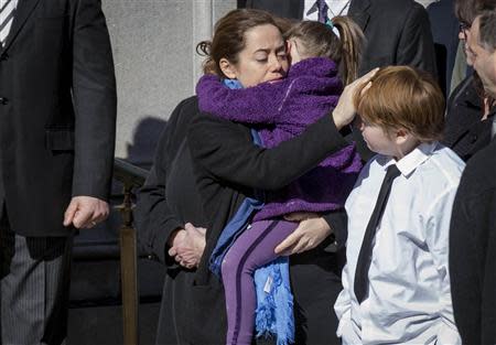 Mimi O'Donnell, former partner of actor Phillip Seymour Hoffman, holds her daughter Willa as she touches the head of their son Cooper as the casket arrives for the funeral of actor Hoffman in the Manhattan borough of New York, February 7, 2014. REUTERS/Brendan McDermid