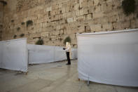 An ultra-Orthodox Jewish man prays ahead of the Jewish new year at the Western Wall, the holiest site where Jews can pray in Jerusalem's old city, Wednesday, Sept. 16, 2020. A raging coronavirus outbreak is casting a shadow over the normally festive Jewish New Year. With health officials recommending a nationwide lockdown, traditional family gatherings will be muted, synagogue prayers will be limited to small groups and roads will be empty. (AP Photo/Sebastian Scheiner)