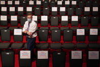 An official walks past spectator seating marked with signs observing social distancing requirments as preparations take place for the second Presidential debate between President Donald Trump and Democratic presidential candidate, former Vice President Joe Biden at Belmont University, Thursday, Oct. 22, 2020, in Nashville, Tenn. (AP Photo/Patrick Semansky)