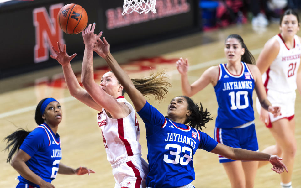Nebraska's Maggie Mendelson and Kansas' Nadira Eltayeb (33) vie for a rebound during the first half of an NCAA college basketball game Wednesday, Dec. 21, 2022, in Lincoln, Neb. (Kenneth Ferriera/Lincoln Journal Star via AP)