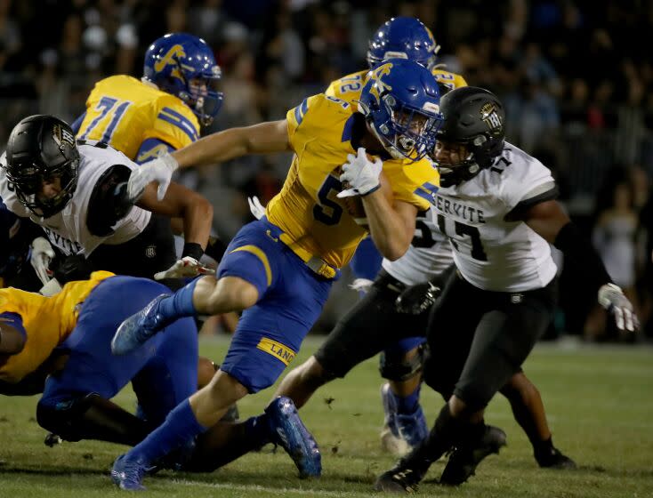 LA PUENTE, CALIF. - SEP 9, 2021. Bishop Amat running back Aiden Ramos makes a short gain against Servite on Thursday night, Sep. 9, 2021. (Luis Sinco / Los Angeles Times)