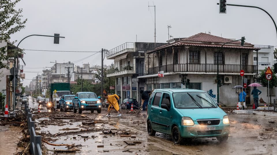 Cars drive among debris and mud, following a flash flood during a storm in the city of Volos, Greece, September 5, 2023.  - Anastasia Karekla/Eurokinissi/Reuters