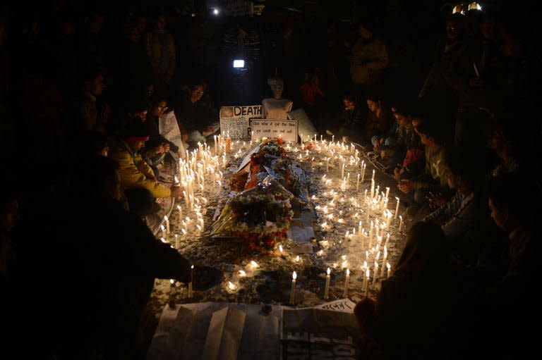 Indain protestors light candles around a mannequin representing the rape victim during a rally in New Delhi on December 31,2012. The family of an Indian gang-rape victim said Monday they would not rest until her killers are hanged as police finalised their investigation before charges are laid against suspects this week